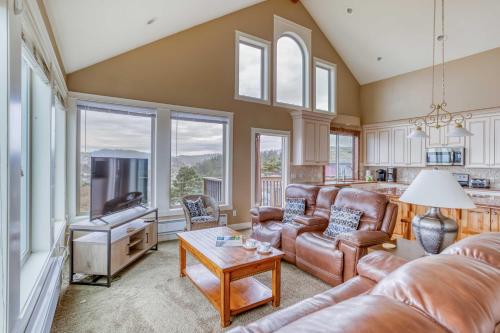 a living room with a couch and a table at Lincoln City Beach House in Lincoln City