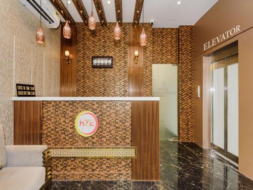 a lobby of a hotel with a sign on the wall at Hotel Zillion Executive Near US Consulate Bandra Kurla Complex Mumbai Near Mumbai Airport Mumbai in Mumbai