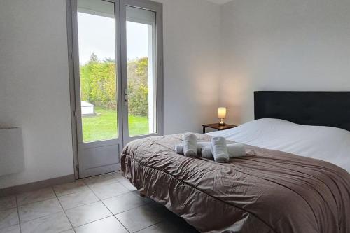 a bedroom with a bed with two pillows on it at Pavillon 3 chambres avec piscine, Garat (16) in Garat