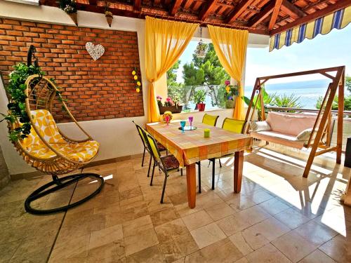 a living room with a wooden table and chairs at Apartments Tempera by the beach in Split