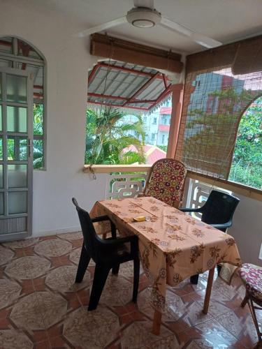 a dining room with a table and chairs at Fleurvilla in Pereybere