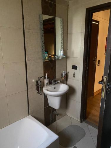 a bathroom with a sink and a mirror at Airport Rooftop Club in Cairo