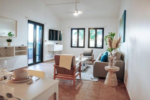 a living room with a couch and a table at Hidden Gem @ Palmas Del Mar w/ View of Marina 999 in Humacao