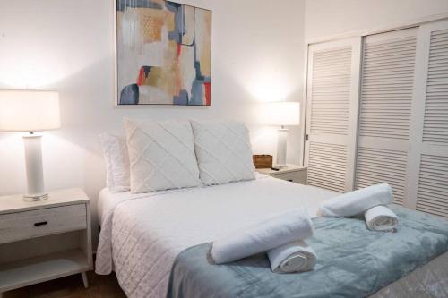 a bedroom with a bed with two towels on it at Hidden Gem @ Palmas Del Mar w/ View of Marina 999 in Humacao