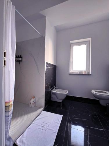a bathroom with a sink and a toilet and a shower at Apartament B&B Cajvana in Cajvana