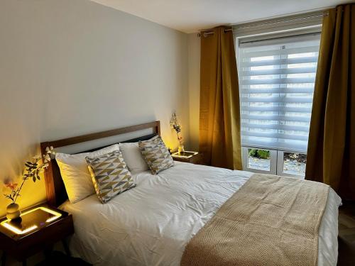a bedroom with a bed with pillows and a window at Gero's One Bedroom apartment London NW8 in London
