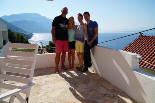 a group of people standing on a balcony with the ocean at Hostel Dalmatia in Marusici 