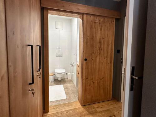 an open door to a bathroom with a toilet at Chic Alpine Elegance: Designer Retreat in Samedan in Samedan