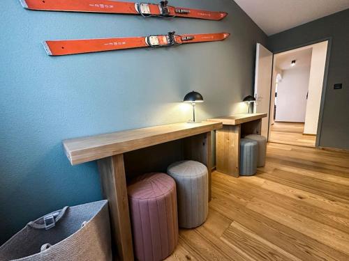 a room with two tables and stools in a room at Chic Alpine Elegance: Designer Retreat in Samedan in Samedan