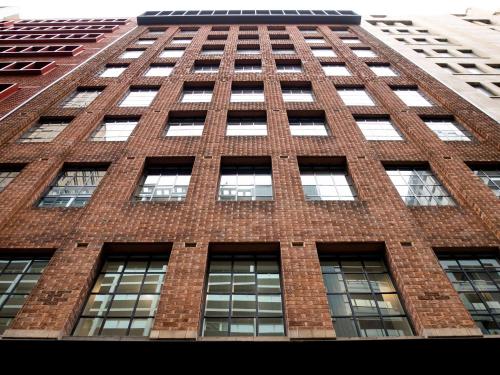 a tall brick building with lots of windows at The Sebel Sydney Martin Place in Sydney