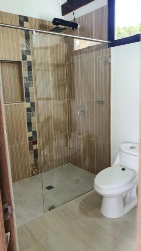a bathroom with a shower and a toilet at Cabañas Villa Celeste in Villa de Leyva