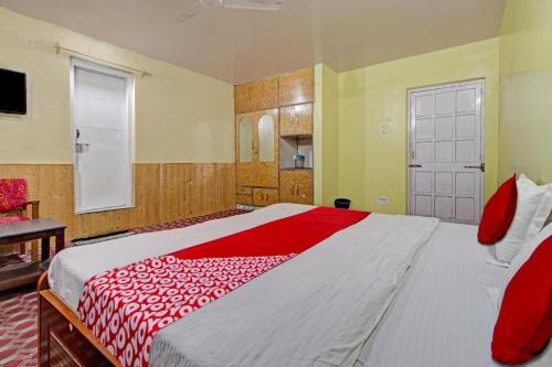 a bedroom with a large bed with a red blanket at Hotel Ab-i-Hayat in Srinagar