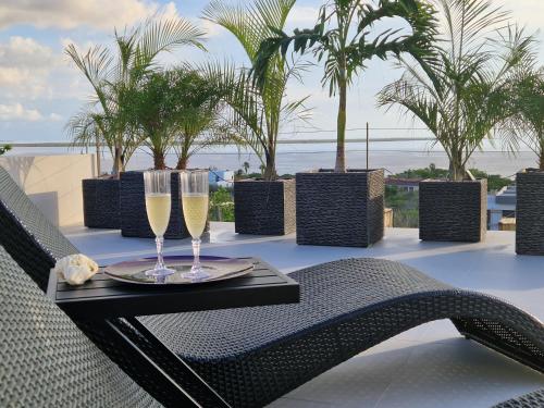 a table with two glasses of champagne on a balcony at Villa Regatta in Hato