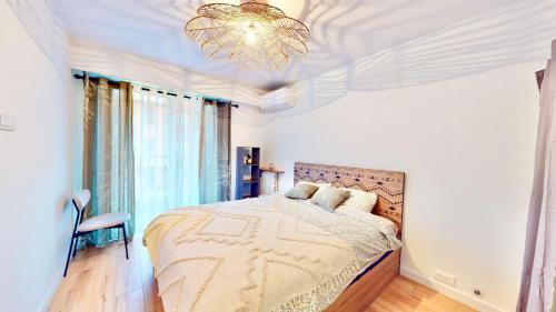 une chambre avec un lit et un lustre dans l'établissement Cosy, 1 bedroom near Port, à Nice