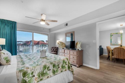 a bedroom with a bed and a dresser and a window at Maravilla 1309 in Destin
