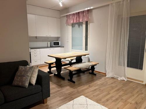 a living room with a table and a couch at Apartment Korsholma2 in Vaasa