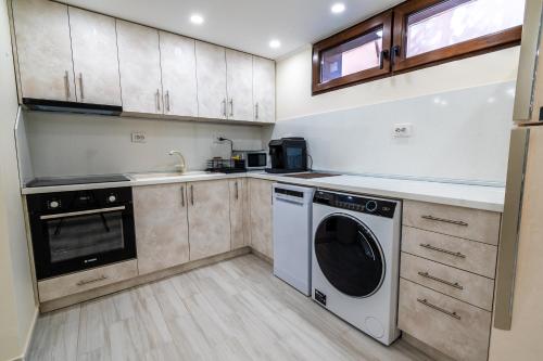 a kitchen with a washer and dryer in it at Sweet Home in Sofia