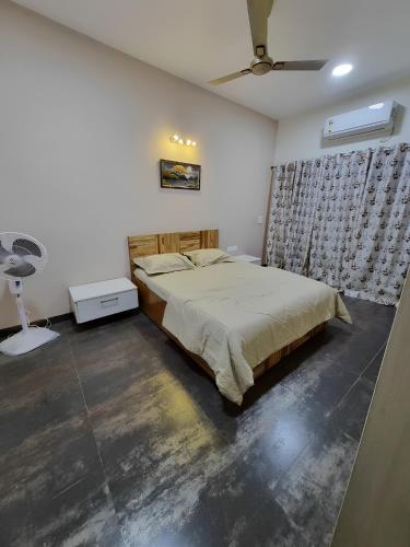 a bedroom with a bed and a ceiling fan at Antalya Villa in Malavli