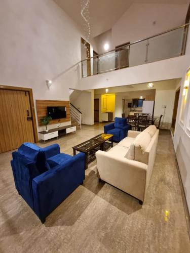 a large living room with couches and a tv at Antalya Villa in Malavli