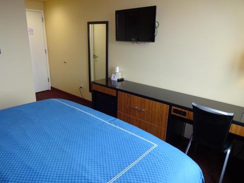a room with a bed and a tv on the wall at Hotel Bliss - Brooklyn in Brooklyn