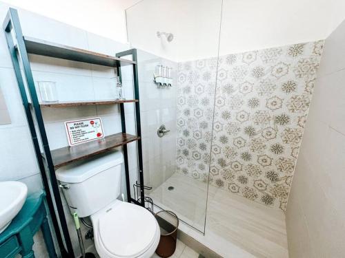 a small bathroom with a toilet and a shower at Picaflor 10 Spacious Elegant PH Apt @ Miramar in San Juan