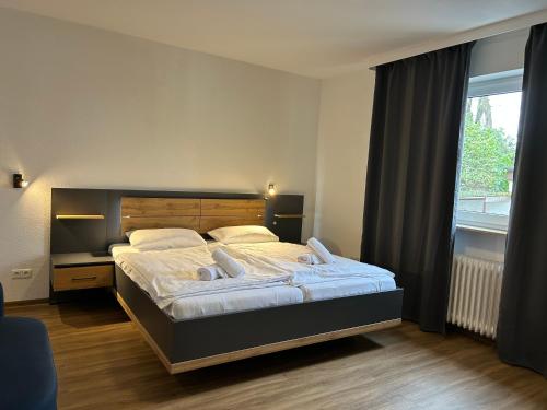 a bedroom with a large bed and a window at Riverside Airport Hotel in Kelsterbach