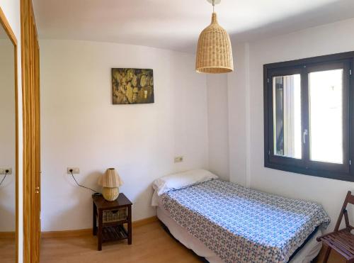 a small bedroom with a bed and a window at Casa Chuanina in Benasque