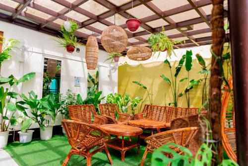 a patio with a table and chairs and plants at DENGI INN EL NIDO in El Nido