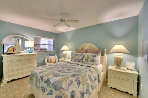a bedroom with a bed and two dressers and a mirror at Emerald Isle 603 in St Pete Beach