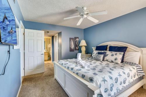 a bedroom with a bed and a ceiling fan at Emerald Isle 602 in St Pete Beach