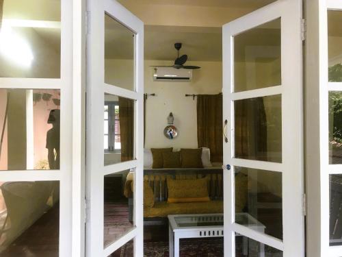 a living room with a couch through a door at Marari Dreamz Homestay in Mararikulam