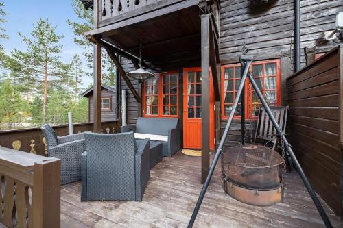 a porch of a cabin with a large barrel at Cozy cabin with great view and immediate proximity to the ski resort and swimming area in Vradal