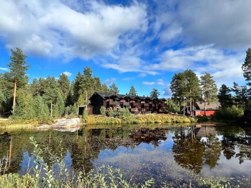 a view of the lodge from the lake at Cozy cabin with great view and immediate proximity to the ski resort and swimming area in Vradal