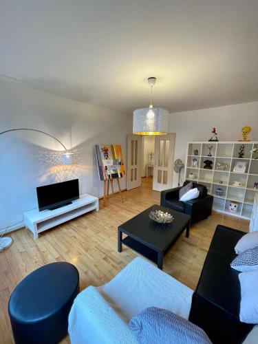 a living room with a couch and a table at Appartement Hyper Centre Place Kléber in Strasbourg