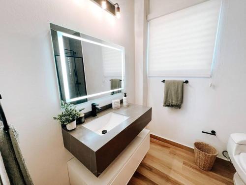 a bathroom with a sink and a mirror at Boho Style House Super Comfortable For 5@ San Juan rey 2 apt 1 in San Juan