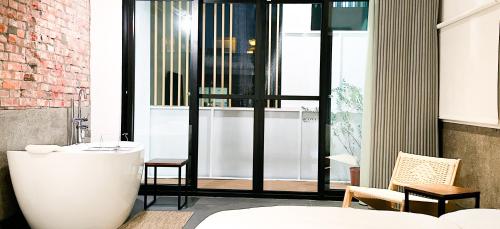 a bathroom with a bath tub and a window at UNS B&B in Kaohsiung