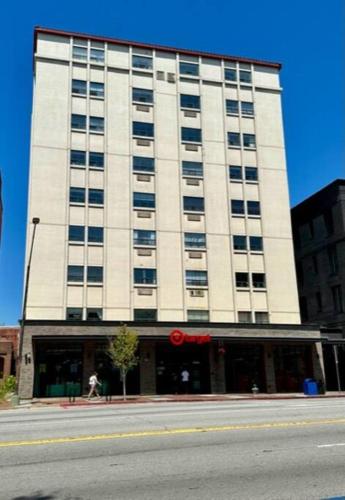 a tall building on the corner of a street at UGA Penthouse Downtown Athens Walk To Stadium in Athens