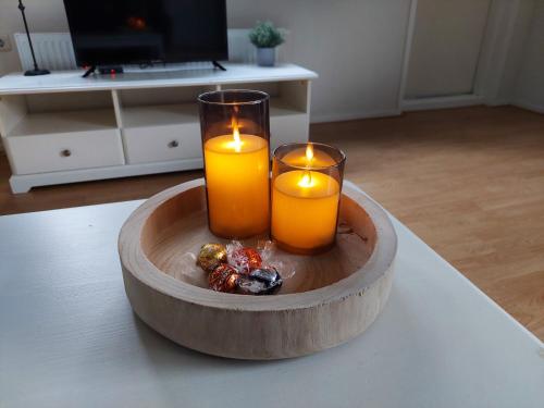 two candles in a bowl on a table at Huisje nr. 18 met jacuzzi in Putten