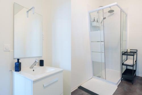 a white bathroom with a sink and a shower at Le Fleur de Cerisier - ZMN Conciergerie in Saint-Quentin