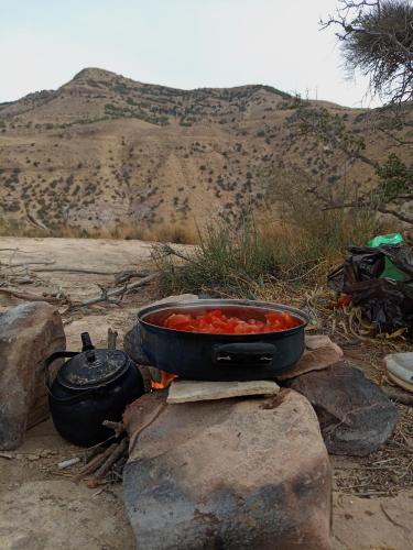 a pot of food sitting on top of a fire at Dana Rose camp outdoor camping in Dana