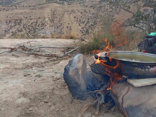 a pot of water sitting on top of a fire at Dana Rose camp outdoor camping in Dana