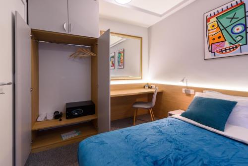 a hotel room with a bed and a desk at LOCATION in Sofia