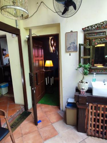 a hallway with a door and a sink in a room at Cintra House Penang in George Town