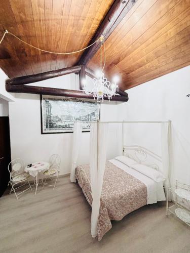 a bedroom with a bed and a wooden ceiling at Residenza Bra Verona in Verona
