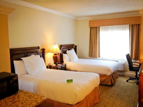 a hotel room with two beds and a window at Amelia Hotel at the Beach in Fernandina Beach