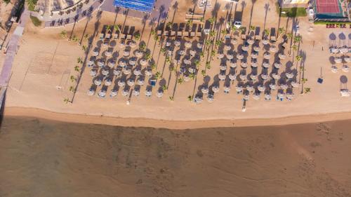 Amwaj Beach Club Abu Soma في الغردقة: اطلالة علوية على شاطئ به مظلات وكراسي