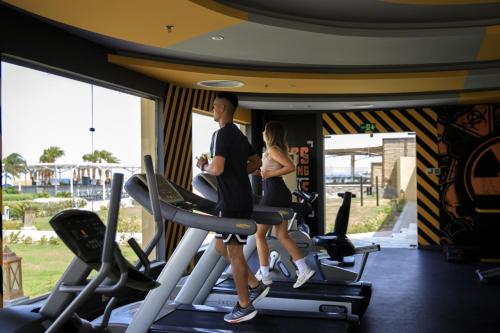 a man and woman on treadmills in a gym at Amwaj Beach Club Abu Soma in Hurghada