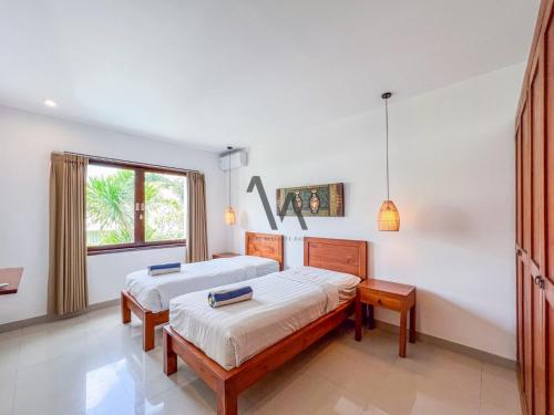 Postel nebo postele na pokoji v ubytování Villa Alamanda Canggu Bali