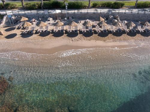 an aerial view of a beach with umbrellas and the ocean at Coral Hotel Athens in Athens