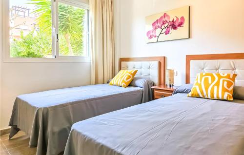 dwa łóżka w pokoju z oknem w obiekcie Cozy Apartment In Casares With Swimming Pool w mieście Casares